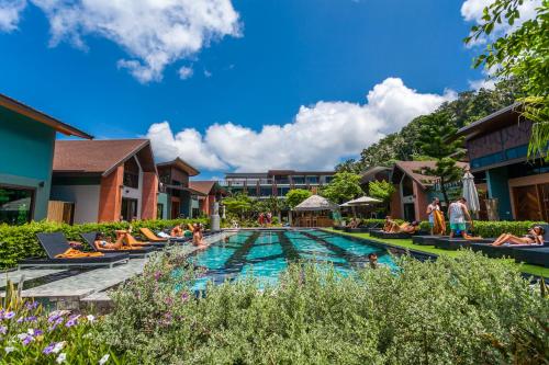皮皮岛ChaoKoh Phi Phi Hotel and Resort- SHA Extra Plus的度假村的游泳池,周围的人在