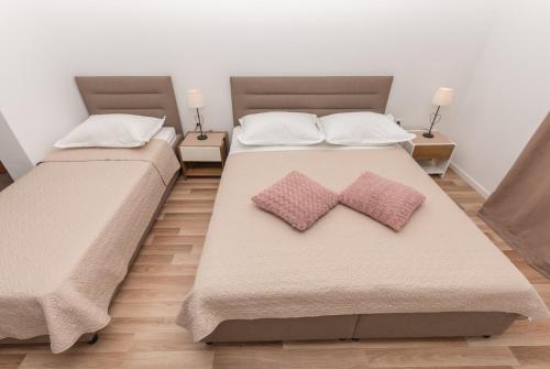 巴什卡沃达Apartments Nina M的卧室内的两张床和枕头