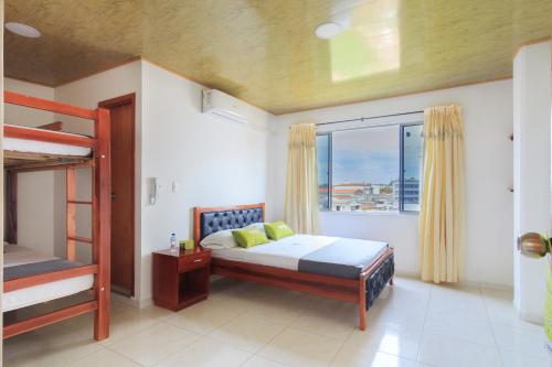 布卡拉曼加Hotel El Rubí的一间卧室设有两张双层床和一扇窗户。