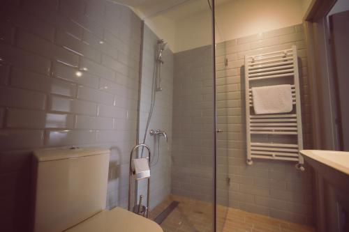 巴克乌Villa Piazzetta的一间带卫生间和玻璃淋浴间的浴室
