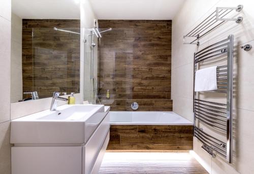 派克波特斯耐兹库HOTEL PECR DEEP的浴室配有白色水槽和浴缸。