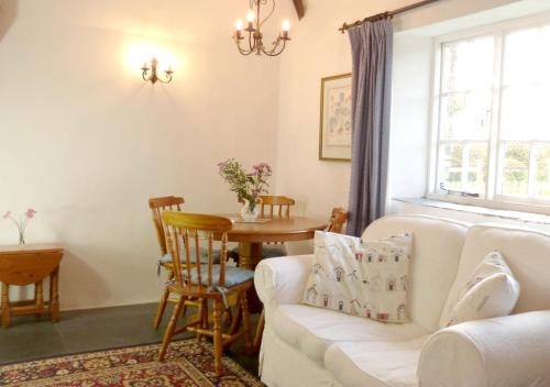 卡姆尔福德Old Newham Farm的客厅配有白色的沙发和桌子