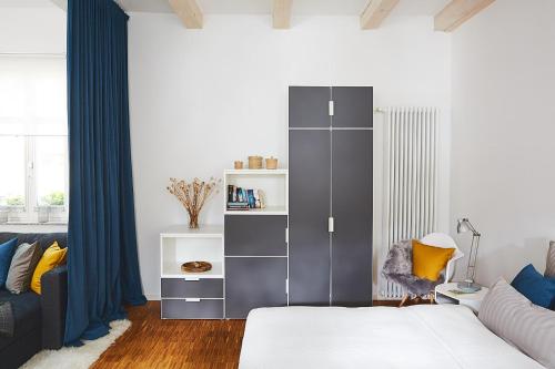 泰尔托Altstadtloft Teltow的一间卧室配有大型灰色橱柜和沙发