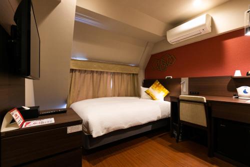 东京蒲田/羽田红屋顶经济型酒店客房内的一张或多张床位