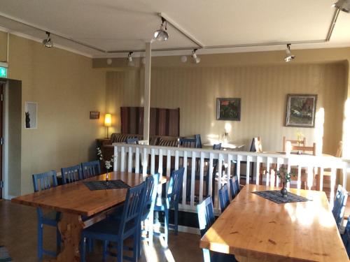 恩舍尔兹维克Örnsköldsviks Vandrarhem的用餐室配有木桌和蓝色椅子