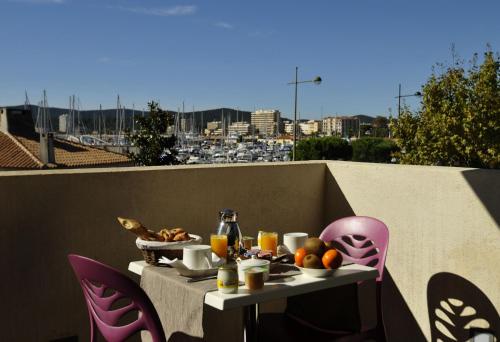 勒拉旺杜巴普迪斯丁酒店的阳台上的桌子上摆放着食物和饮料