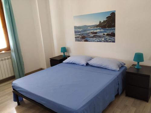 费拉约港Bell'appartamento的卧室配有一张床,墙上挂有绘画作品