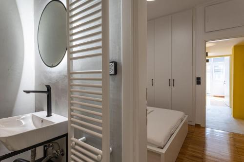 雅典Luxury Penthouse on Akadimias with 2 Bed & 2 Bath的一间带水槽和镜子的浴室以及一张床