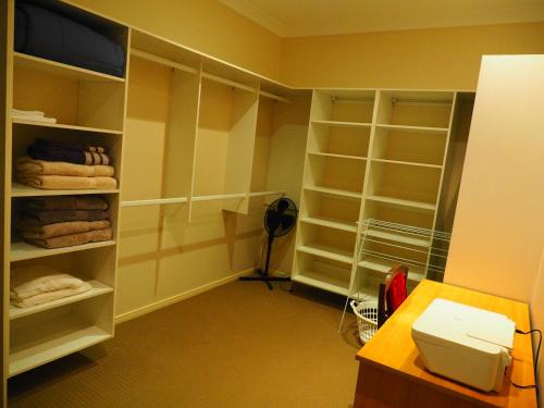 Mount OmmaneyAccommodation on Westlake Mount Ommaney的客房设有带架子的衣柜和卫生间。
