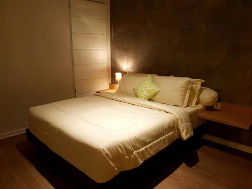 三宝垄Graha Padma Avonia的卧室配有一张带白色床单和枕头的大床。