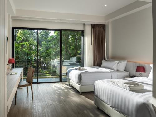 T-REX BURIRAM BOUTIQUE HOTEL New Hotel in Buriram客房内的一张或多张床位