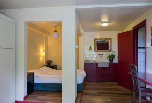 奥依吉Hotel Restaurant Oortjeshekken的一间带床的小卧室和一间厨房