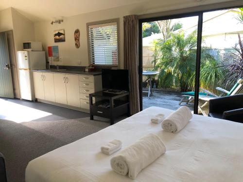 泰鲁阿泰鲁阿海岸汽车旅馆的卧室配有白色床和毛巾