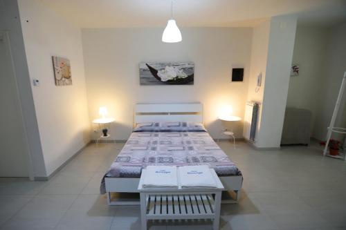 滨海波利尼亚诺Casa Mascagni的一间设有两张床的卧室,位于带灯光的房间