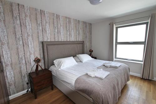 圣布雷拉德Corbiere Phare Apartments的一间卧室配有一张床,上面有两条毛巾