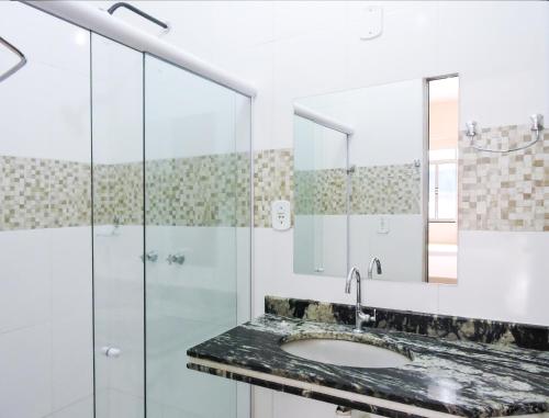 阿拉卡茹雷奥德索尔酒店的一间带水槽和玻璃淋浴的浴室