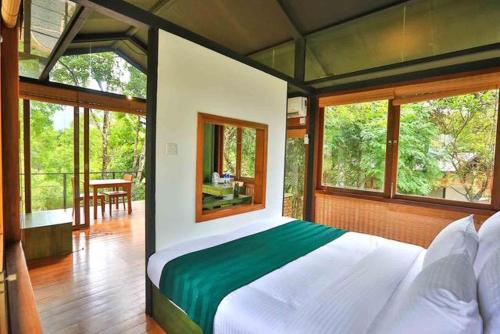 贝里胡罗亚Sennya Resorts的一间带一张大床的卧室,位于带窗户的房间内