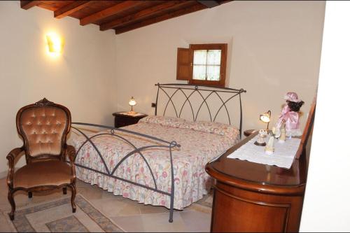 阿夏诺Sant'Ippolito的一间卧室配有一张床、一把椅子和一张桌子