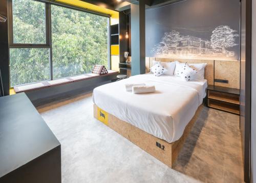 曼谷LOBSUEK Hostel หลบศึก โฮสเทล的一间卧室设有一张大床和一个大窗户