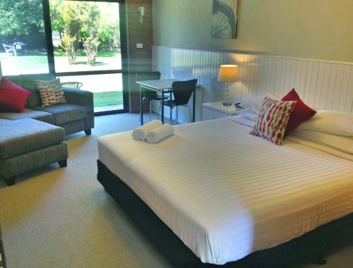 布赖特Motel Sierra - Bright的一间带白色大床的卧室和一间客厅