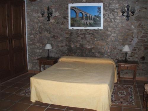 卡隆赫Villa mas的一间卧室配有一张床和两张带台灯的桌子。
