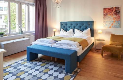 卢塞恩Neustadt Apartments managed by Hotel Central Luzern的一间卧室配有一张大床和蓝色床头板