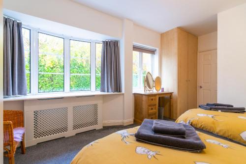 BramhallThe Garden Apartment的一间卧室设有两张床和窗户。