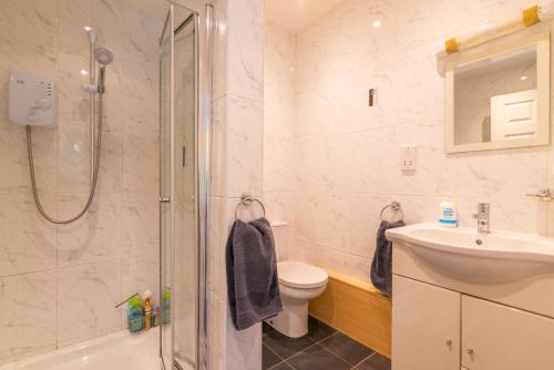 BramhallThe Garden Apartment的带淋浴、卫生间和盥洗盆的浴室
