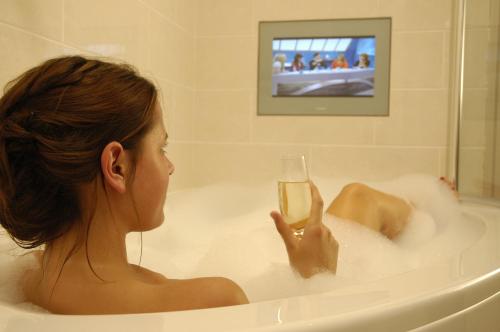 海景城海景酒店&餐厅的坐在浴缸里拿着一杯葡萄酒的女人