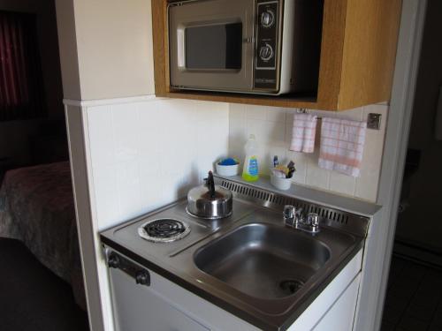 BarrièreY-5汽车旅馆的厨房配有水槽和微波炉