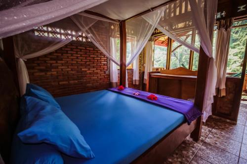 武吉拉旺Garden Inn的一间帐篷内带蓝色床的卧室