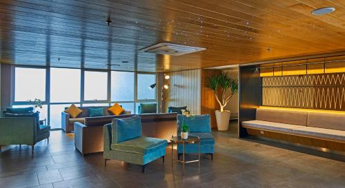 云顶高原云顶高原瑞园酒店及高级公寓的大堂设有蓝色的椅子、一张沙发和一张桌子