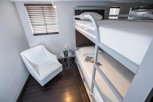 迈阿密海滩珀斯南海滩酒店的小房间设有双层床和椅子