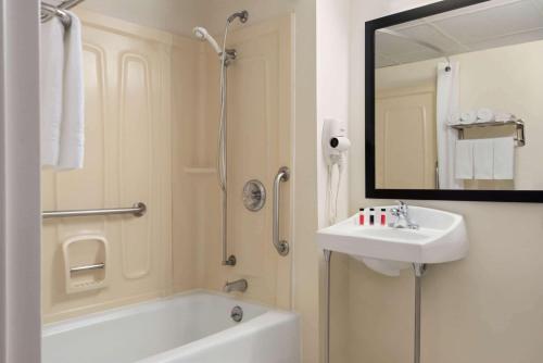 利物浦利物浦/雪城北机场速8酒店的带浴缸、水槽和镜子的浴室