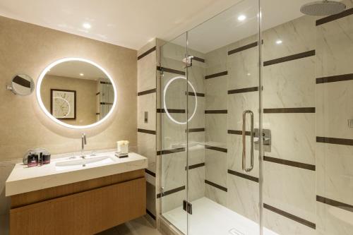曼彻斯特罗科·福尔蒂劳里酒店的浴室配有盥洗盆和带镜子的淋浴