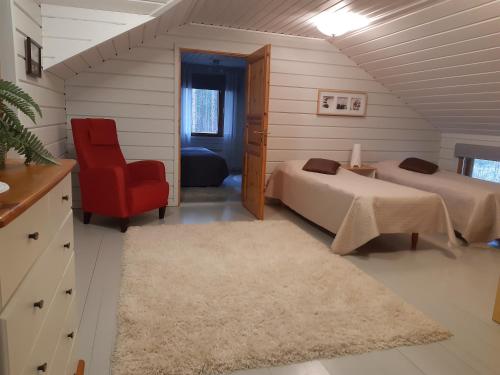 OravisaloTopin Tupa 1的一间卧室配有两张床和红色椅子