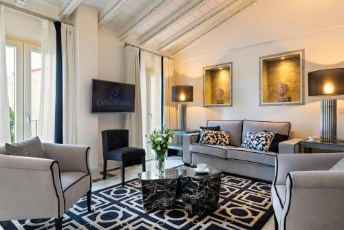 塞维利亚Casa de Triana Luxury Suites by Casa del Poeta的客厅配有沙发和桌子
