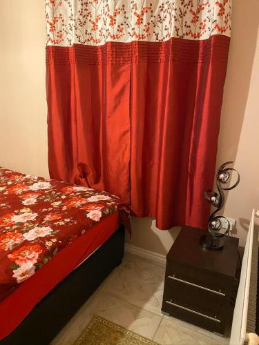 牛津Guest House B&B的一间卧室配有床和红色窗帘