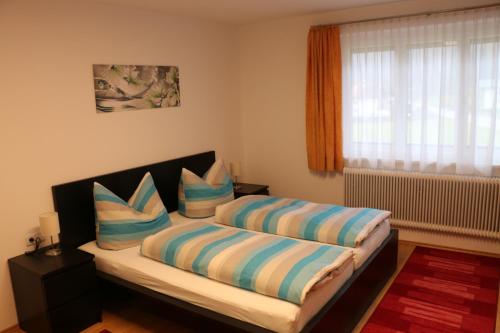 万丹斯Gästehaus Schoder的一间卧室配有一张带两个枕头的床
