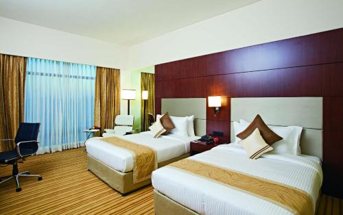 萨希巴巴德丽怡酒店及套房客房内的一张或多张床位