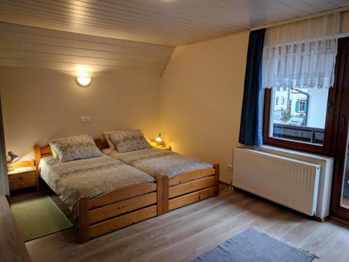 克拉尼斯卡戈拉Apartma Kramar Podkoren的一间卧室设有两张床和窗户。