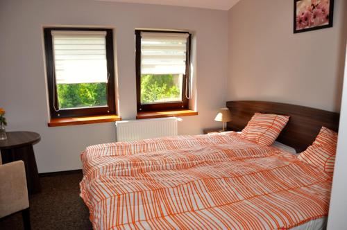 波别济斯卡马奇约娃查塔乡村民宿的一间卧室设有一张床和两个窗户。