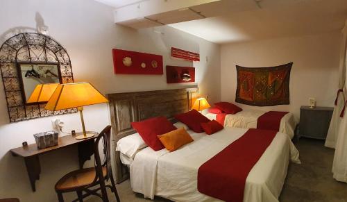 阿利坎特巴里奥布提克旅舍的一间卧室配有两张床、一张桌子和一面镜子