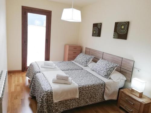 普拉德埃米塔APARTAMENT CA DE GALLISCA B 4PAX的一间卧室配有一张床,上面有两条毛巾