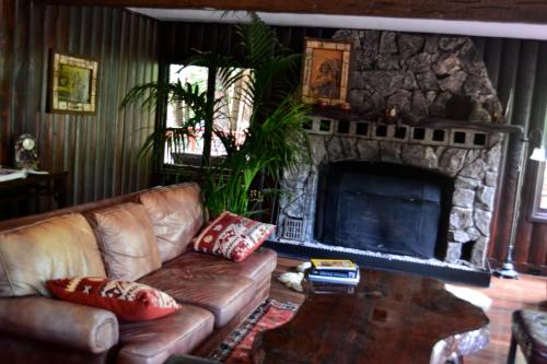 盖尔南维尔Guerneville Lodge的带沙发和石制壁炉的客厅