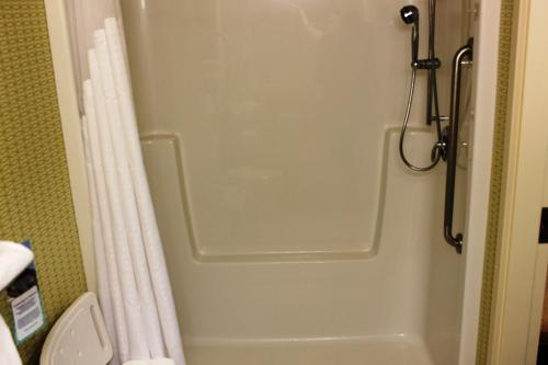 约克顿约克顿东部智选假日酒店的一间带卫生间的浴室内的淋浴门