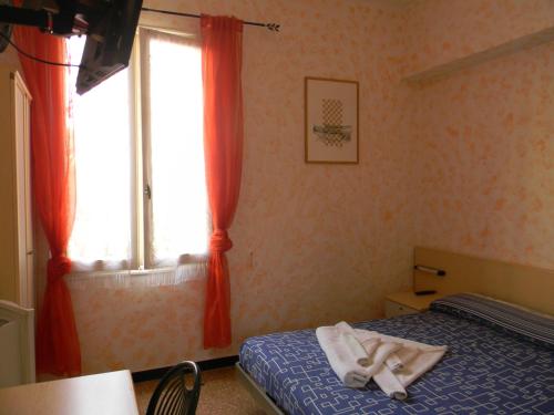 瓦拉泽Vecchie Mura的一间卧室配有床和橙色窗帘的窗户