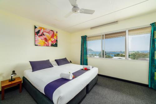 维拉港卡维缇汽车旅馆的一间卧室设有一张大床和一个窗户。