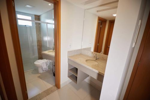 卡达斯诺瓦斯Resort do Lago - Caldas Novas的一间带水槽、卫生间和镜子的浴室