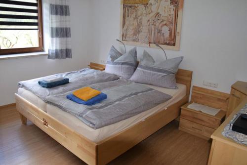 马耳他Ferienwohnung Strasser的一间卧室配有木床和2条毛巾